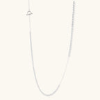 Long sterling silver beaded necklace with graduated sphere design, toggle clasp, and delicate chain extension on white background